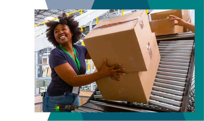 Black woman in warehouse moving boxes