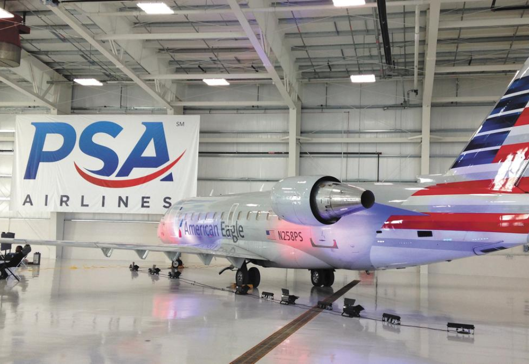 PSA Airlines plane sits in a hanger